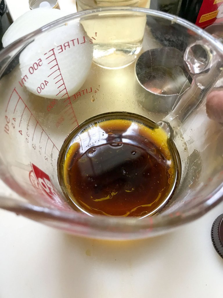 Oil vinegar, sugar, salt, pepper and Maggie Seasoning in a measuring cup
