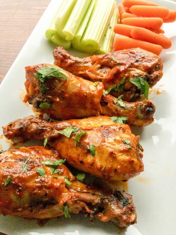 Buffalo chicken drumsticks with carrots and celery