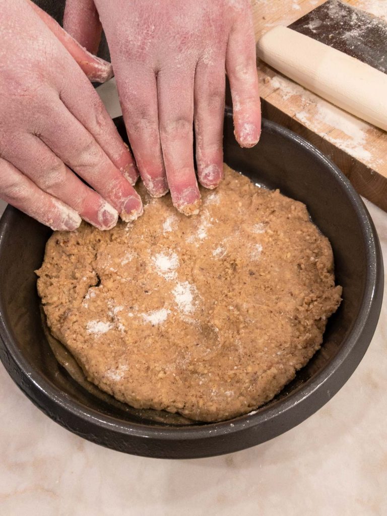 Pressing dough into cake pan